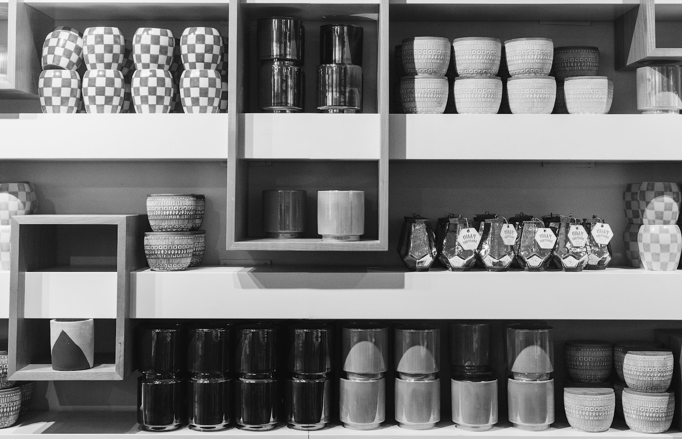 a shelf filled with lots of different types of cups