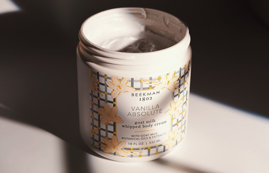A jar of body cream is being photographed.