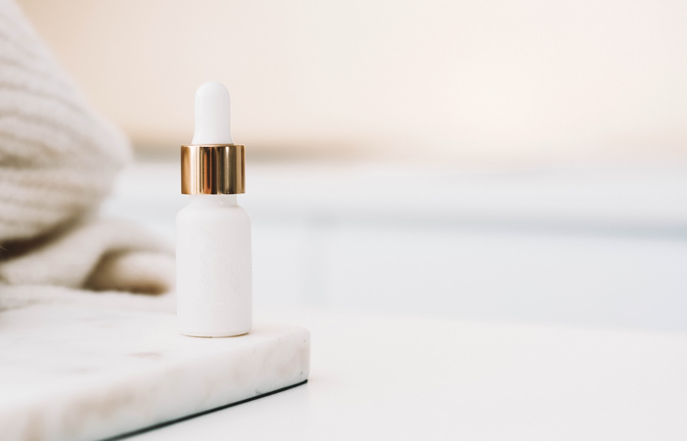 white drop bottle on white surface
